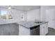 Modern kitchen featuring stainless steel appliances, a granite island, white cabinets, and hardwood flooring at 2118 Willow Gln Dr, Graham, NC 27253