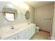 Bathroom features a double sink vanity, large mirrors, and tile flooring at 212 Columbia W Pl, Chapel Hill, NC 27516