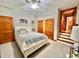 Spacious bedroom with hardwood doors, a double closet, carpet, and a ceiling fan at 212 Columbia W Pl, Chapel Hill, NC 27516