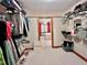 Walk in closet features ample shelving and a view into an adjacent bedroom at 212 Columbia W Pl, Chapel Hill, NC 27516