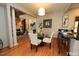 Open dining area with hardwood floors, pendant lighting, and a view of the living room at 212 Columbia W Pl, Chapel Hill, NC 27516