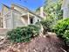 Charming home exterior featuring lush landscaping, arched front door, and attached garage at 212 Columbia W Pl, Chapel Hill, NC 27516