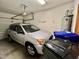 Garage interior with a parked silver SUV and recycling bins at 212 Columbia W Pl, Chapel Hill, NC 27516