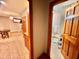 Downstairs hallway with doorways to a full bath and another living area at 212 Columbia W Pl, Chapel Hill, NC 27516
