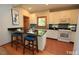 Bright kitchen with white cabinets, granite countertops, and bar seating at 212 Columbia W Pl, Chapel Hill, NC 27516