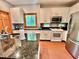 Well-lit kitchen with white cabinetry, granite countertops, and stainless steel appliances at 212 Columbia W Pl, Chapel Hill, NC 27516