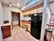 Functional kitchenette with wood cabinets and black refrigerator at 212 Columbia W Pl, Chapel Hill, NC 27516