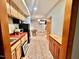 Cozy kitchenette featuring wooden cabinetry, red countertops, and stainless steel appliances at 212 Columbia W Pl, Chapel Hill, NC 27516