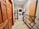 Functional laundry room with washer, dryer, and storage shelves at 212 Columbia W Pl, Chapel Hill, NC 27516