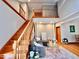 Sun-drenched living room with hardwood floors, staircase, and loft overlooking the space at 212 Columbia W Pl, Chapel Hill, NC 27516