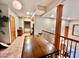 View of the open downstairs living space with a dining table, kitchenette, and staircase at 212 Columbia W Pl, Chapel Hill, NC 27516