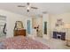 Bedroom with carpet, ceiling fan, dresser, and access to the stairway at 2225 Whistling Straits Way, Raleigh, NC 27604
