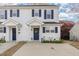 Charming two-story townhouse featuring white siding, navy shutters, and a well-maintained front yard at 2225 Whistling Straits Way, Raleigh, NC 27604