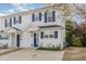Well-maintained townhouse with white siding, blue shutters, and a neatly landscaped front garden at 2225 Whistling Straits Way, Raleigh, NC 27604