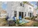 Back of home showing a patio with outdoor furniture and bright blue accents at 2225 Whistling Straits Way, Raleigh, NC 27604
