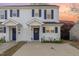 Charming two-story townhouse featuring white siding, navy shutters, and a well-maintained front yard at 2225 Whistling Straits Way, Raleigh, NC 27604