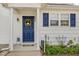 Charming front entry with a navy door, decorative wreath, manicured garden, and inviting curb appeal at 2225 Whistling Straits Way, Raleigh, NC 27604