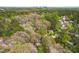 Scenic aerial view showcasing a home nestled amongst lush greenery with the city skyline in the distance at 2400 Perennial St, Raleigh, NC 27603