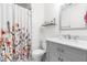 Stylish bathroom featuring a floral shower curtain, modern vanity, and a sleek mirror at 2400 Perennial St, Raleigh, NC 27603
