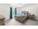 Comfortable bedroom with a ceiling fan, a plush bed, and ample natural light at 2400 Perennial St, Raleigh, NC 27603