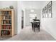 Inviting dining room with a table, chairs, and decorative wall art, adjacent to a bookshelf at 2400 Perennial St, Raleigh, NC 27603