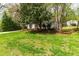 Charming single-story home with mature landscaping and lush green lawn at 2400 Perennial St, Raleigh, NC 27603