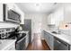 Updated kitchen featuring modern stainless steel appliances, and bright, natural light at 2400 Perennial St, Raleigh, NC 27603