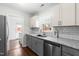 Updated kitchen featuring granite countertops, stainless steel appliances, and bright, natural light at 2400 Perennial St, Raleigh, NC 27603
