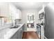 Galley kitchen boasts granite countertops, stainless steel appliances, and views to the breakfast nook at 2400 Perennial St, Raleigh, NC 27603