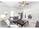 Bright living room with comfortable seating, ceiling fan, and open floor plan at 2400 Perennial St, Raleigh, NC 27603