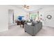 Bright living room with two comfortable sofas, soft carpet, and natural light at 2400 Perennial St, Raleigh, NC 27603
