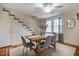 Cozy dining room with hardwood floors, a ceiling fan, and a view of the staircase at 2422 S Alston Ave, Durham, NC 27713