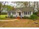 Charming single-story home featuring blue shutters, neutral siding, brick steps, and a well-maintained front yard at 2422 S Alston Ave, Durham, NC 27713