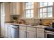 This well-lit kitchen features white cabinetry, stainless steel appliances, and stone countertops at 2422 S Alston Ave, Durham, NC 27713