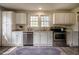 Spacious kitchen features stainless steel appliances, white cabinets, and plenty of natural light at 2422 S Alston Ave, Durham, NC 27713