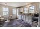 Bright kitchen with stainless steel appliances, white cabinets, and a cozy breakfast nook at 2422 S Alston Ave, Durham, NC 27713