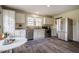 Well-lit kitchen features stainless steel appliances, white cabinetry, and stylish flooring at 2422 S Alston Ave, Durham, NC 27713