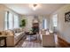 Comfortable living room featuring hardwood floors, a brick fireplace, and ample natural light at 2422 S Alston Ave, Durham, NC 27713