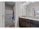 Bright bathroom with a tub/shower combination and dark wood vanity with a granite countertop at 2713 Tunstall Grove Dr, Apex, NC 27523
