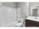 Well-lit bathroom features a tub and shower combo, vanity with sink, and a neutral color scheme at 2713 Tunstall Grove Dr, Apex, NC 27523