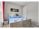 Comfortable bedroom with a wood frame bed and colorful blue and white patterned comforter at 2713 Tunstall Grove Dr, Apex, NC 27523