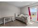 Comfortable bedroom with natural light from the large window and desk at 2713 Tunstall Grove Dr, Apex, NC 27523