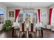 Bright dining room with large windows, modern lighting, and a stylish table setting is perfect for gatherings at 2713 Tunstall Grove Dr, Apex, NC 27523