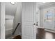 Warm entryway featuring gleaming wood floors and a staircase leading to the second floor at 2713 Tunstall Grove Dr, Apex, NC 27523