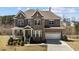 Beautiful two-story home featuring a stone and brick facade and a welcoming front porch at 2713 Tunstall Grove Dr, Apex, NC 27523
