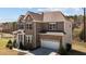 Beautiful two-story home featuring a stone and brick facade and an attached two-car garage at 2713 Tunstall Grove Dr, Apex, NC 27523