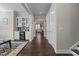 Hallway view of home's dry bar with wine cooler, hardwood floors and neutral walls creating a welcoming atmosphere at 2713 Tunstall Grove Dr, Apex, NC 27523