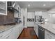 Chef's kitchen with stainless steel appliances, granite countertops, and custom cabinetry provides ample space for cooking at 2713 Tunstall Grove Dr, Apex, NC 27523