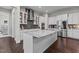 Modern kitchen featuring a large granite island, stainless steel appliances, and ample cabinet space for storage and cooking at 2713 Tunstall Grove Dr, Apex, NC 27523
