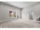 Spacious living room featuring a bright window, plush carpet, neutral walls, and access to other rooms at 2713 Tunstall Grove Dr, Apex, NC 27523